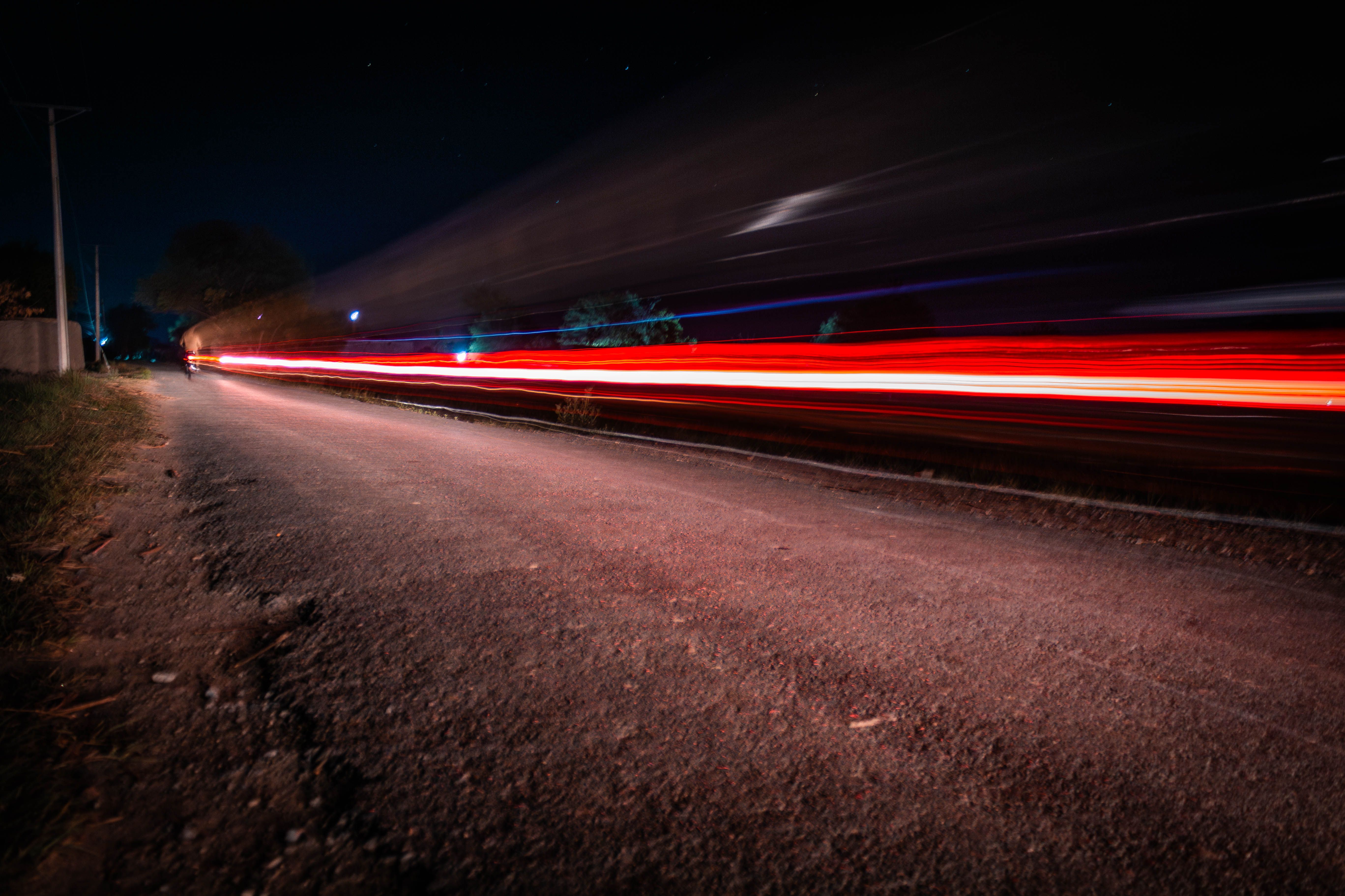 Long exposure depicting motion blur of car lights over an empty rural road at night.. pexels, long, exposure