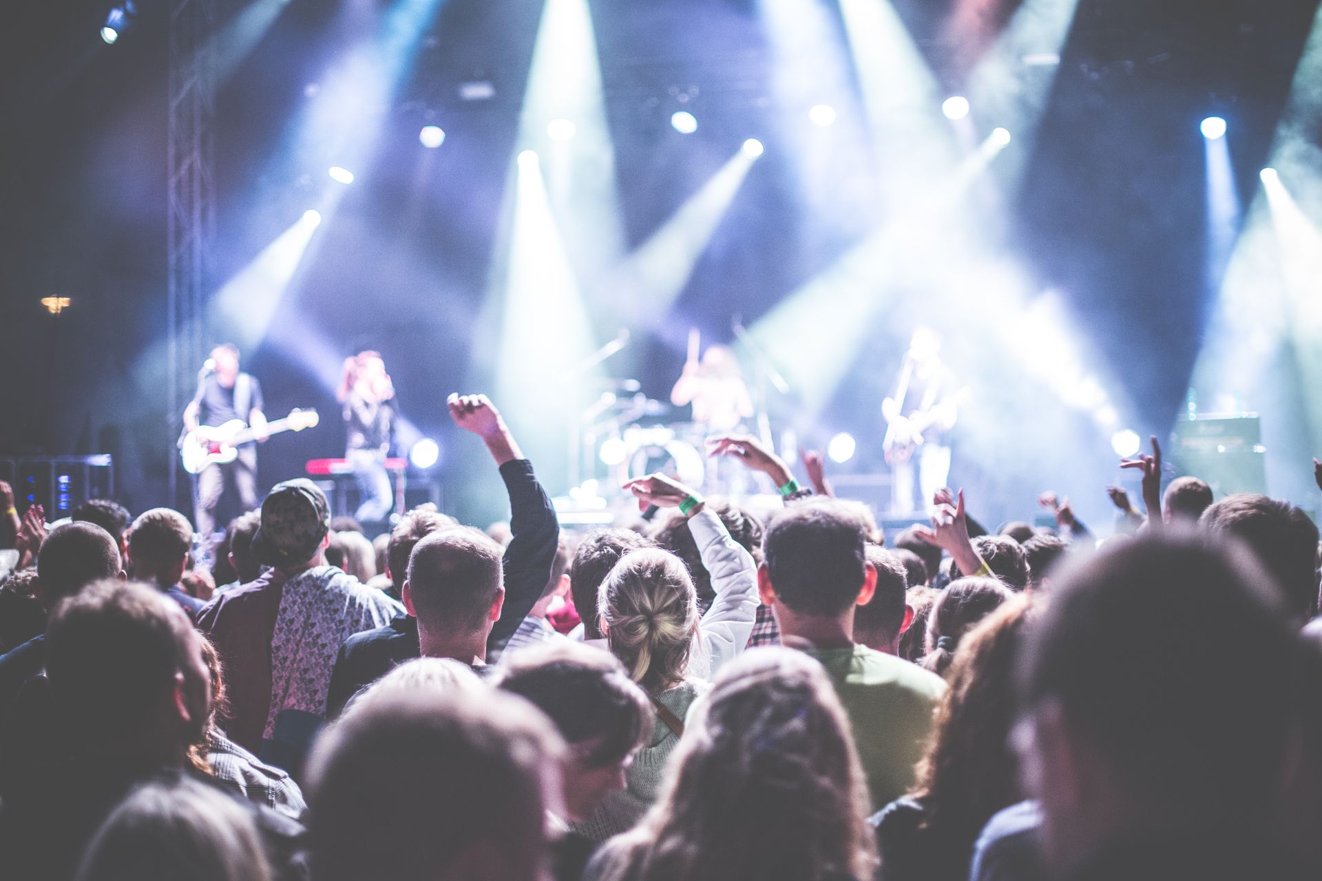 Concert audience in front of a live stage with a band performance