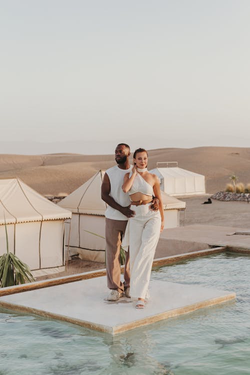 Man and Woman Posing by Swimming Pool