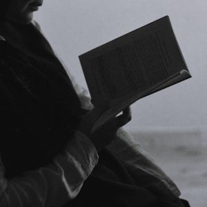 Reader with an open book, photo by Sara Er on Pexels