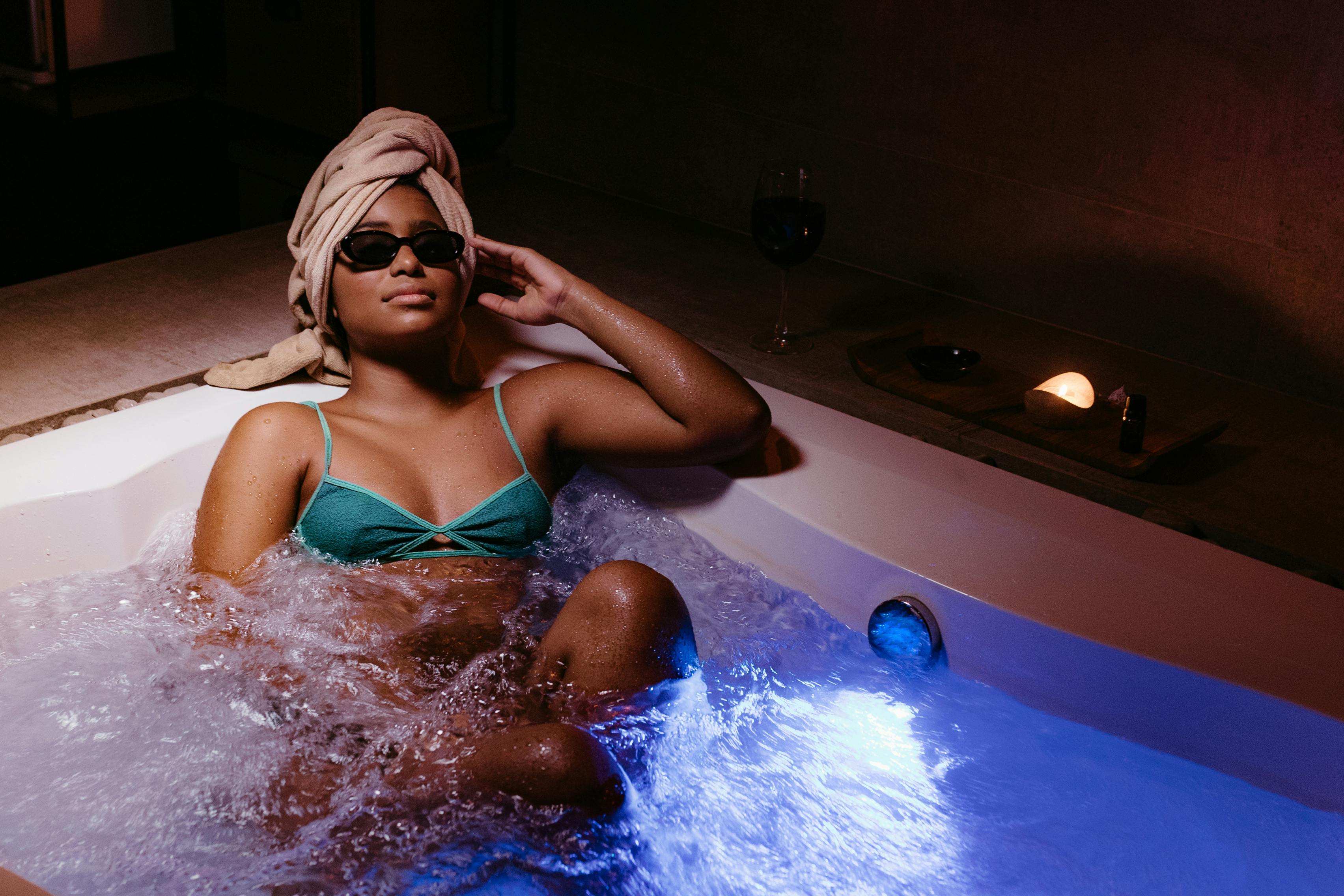 Young Woman in Green Bikini Relaxing in a Hot Tub Free Stock Photo