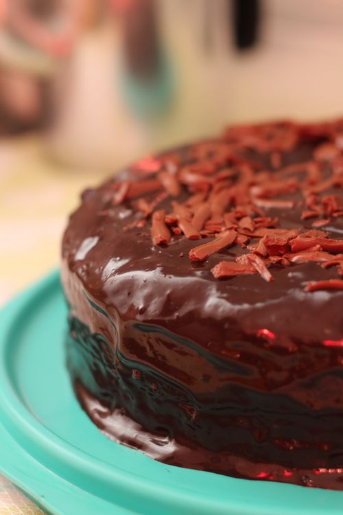 Free Delicious homemade chocolate cake coated with ganache and topped with chocolate shavings. Stock Photo