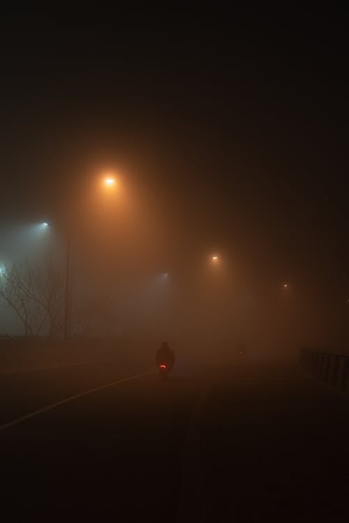 Person Riding a Motorcycle at Night