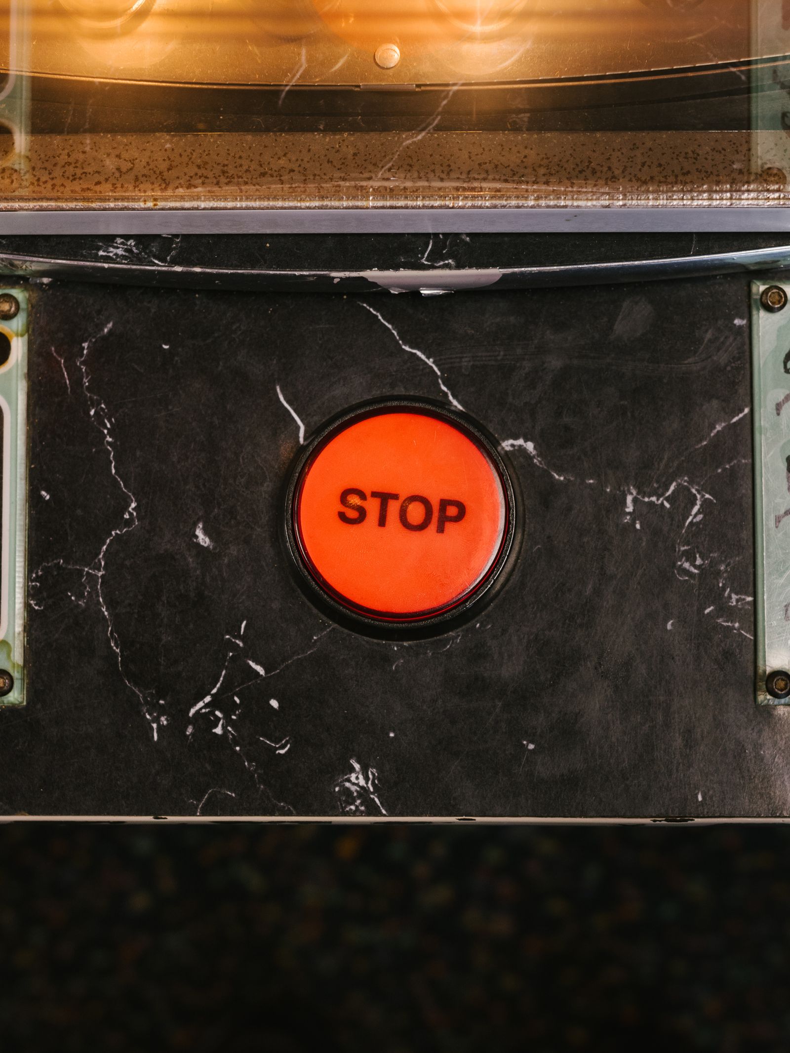 A red emergency stop button on an industrial machine