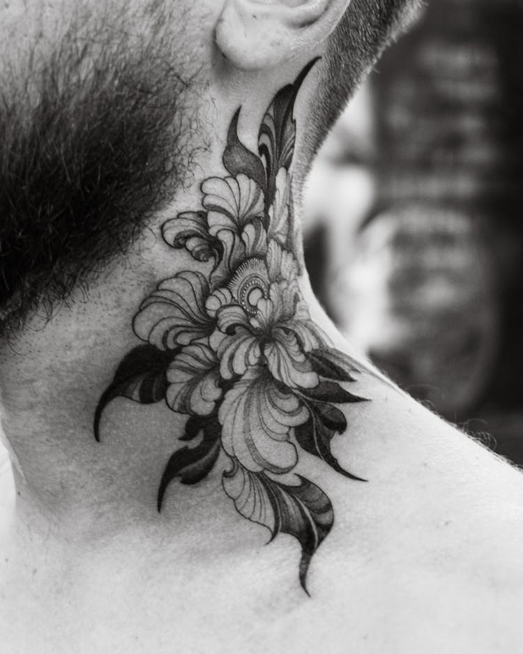 Close-up Of A Neck Tattoo With A Floral Motif 