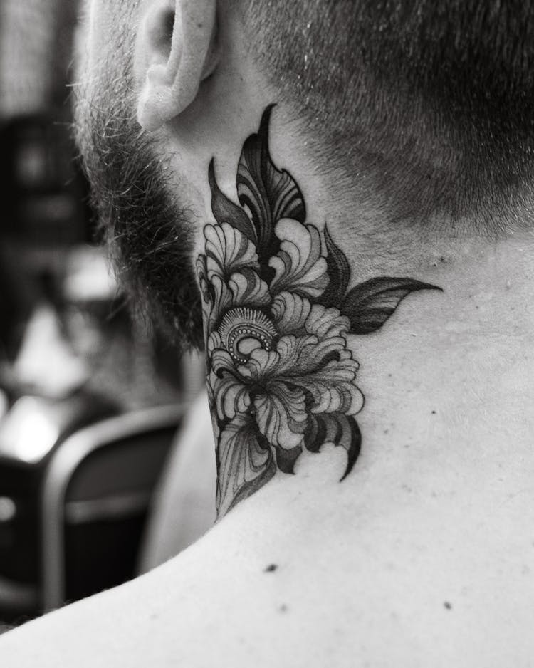 Close-up Of A Neck Tattoo With A Floral Motif