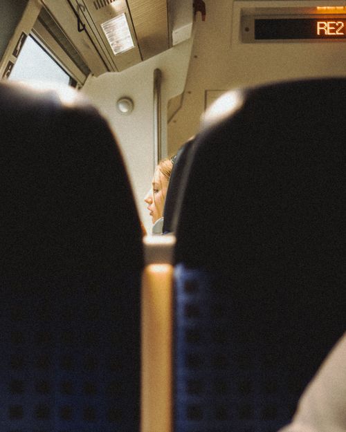 Free Candid shot of a woman sitting inside a USA train, capturing travel and transport essence. Stock Photo