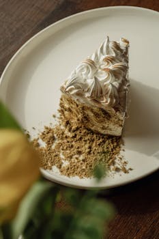 A slice of beautifully decorated cake with texture details on a plate, perfect for food photography.