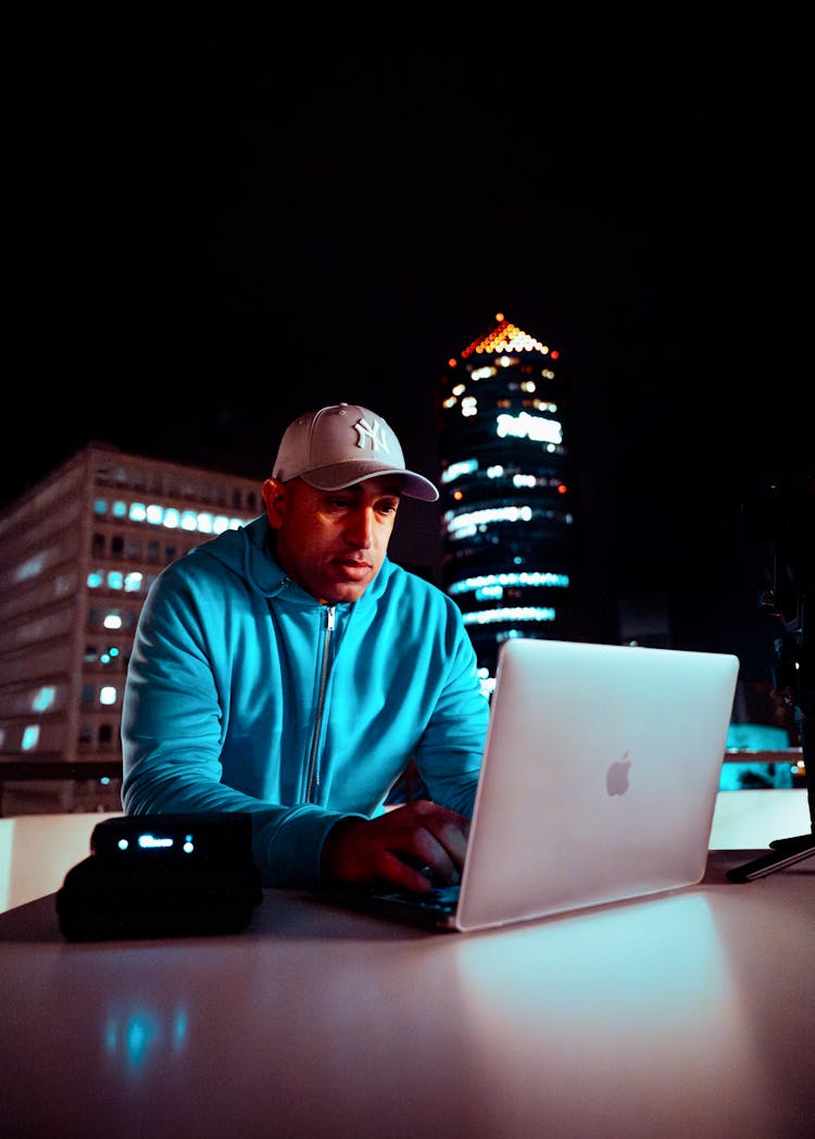 Man Working On A Computer On A Roof 