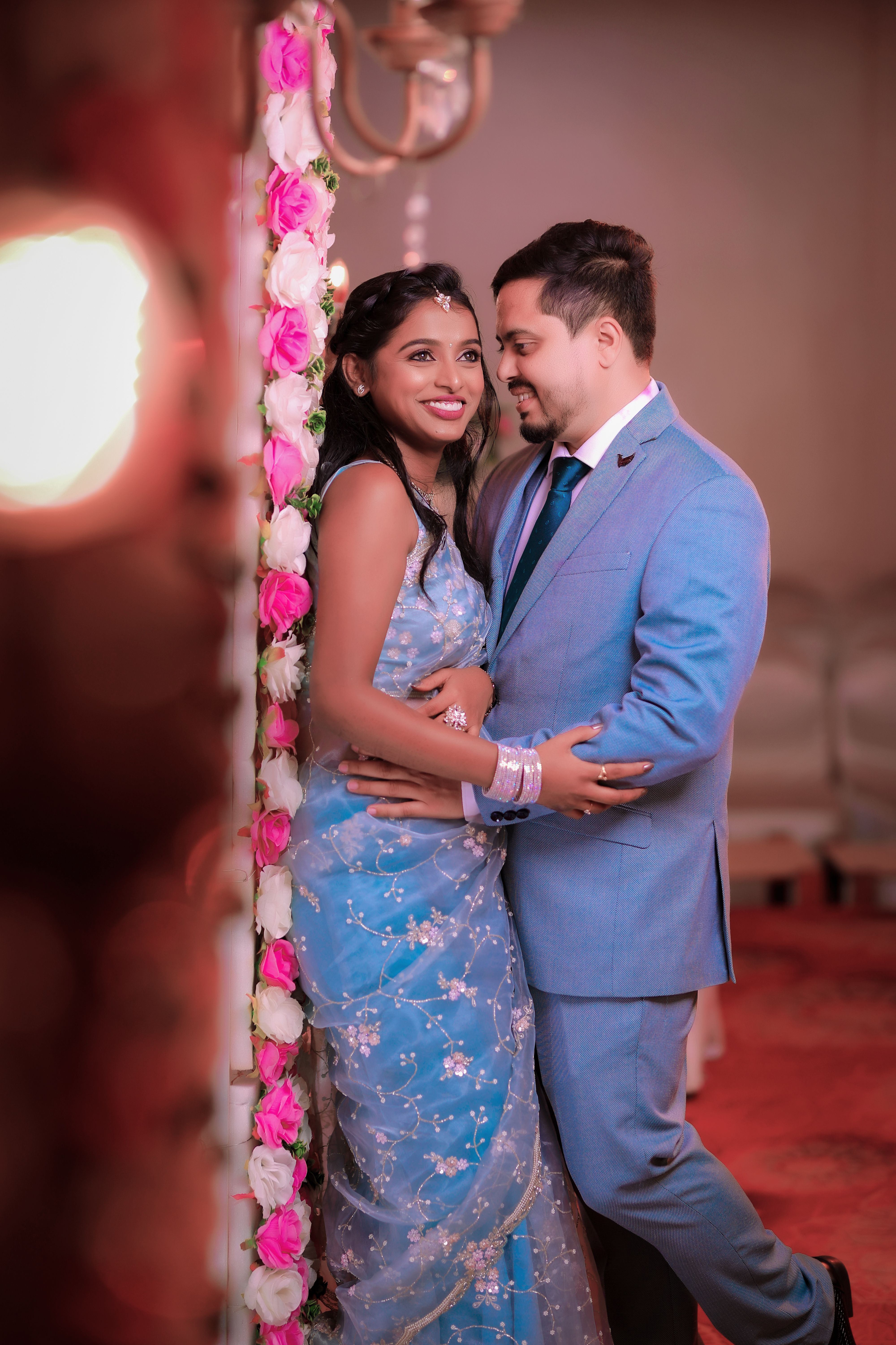 blue and pink couple dress Two Souls,One Story. . Tropical destination wedding vibes Indian couple dressed in pastel wedding outfits, bride in pink saree and groom in sky blue sherwani, sharing a happy moment under floral decor. . . . #