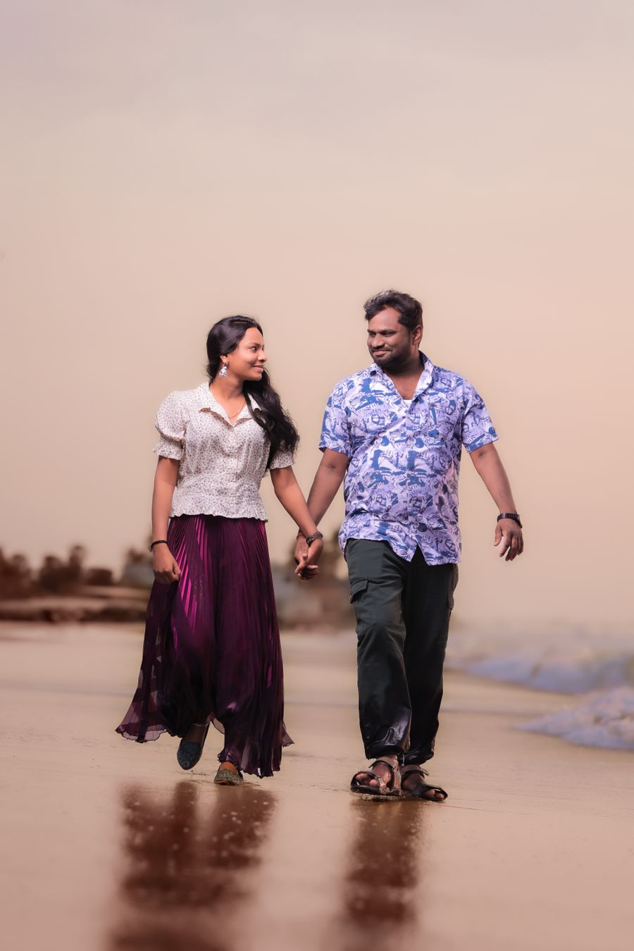Couple walking on the beach on a couples wellness escape