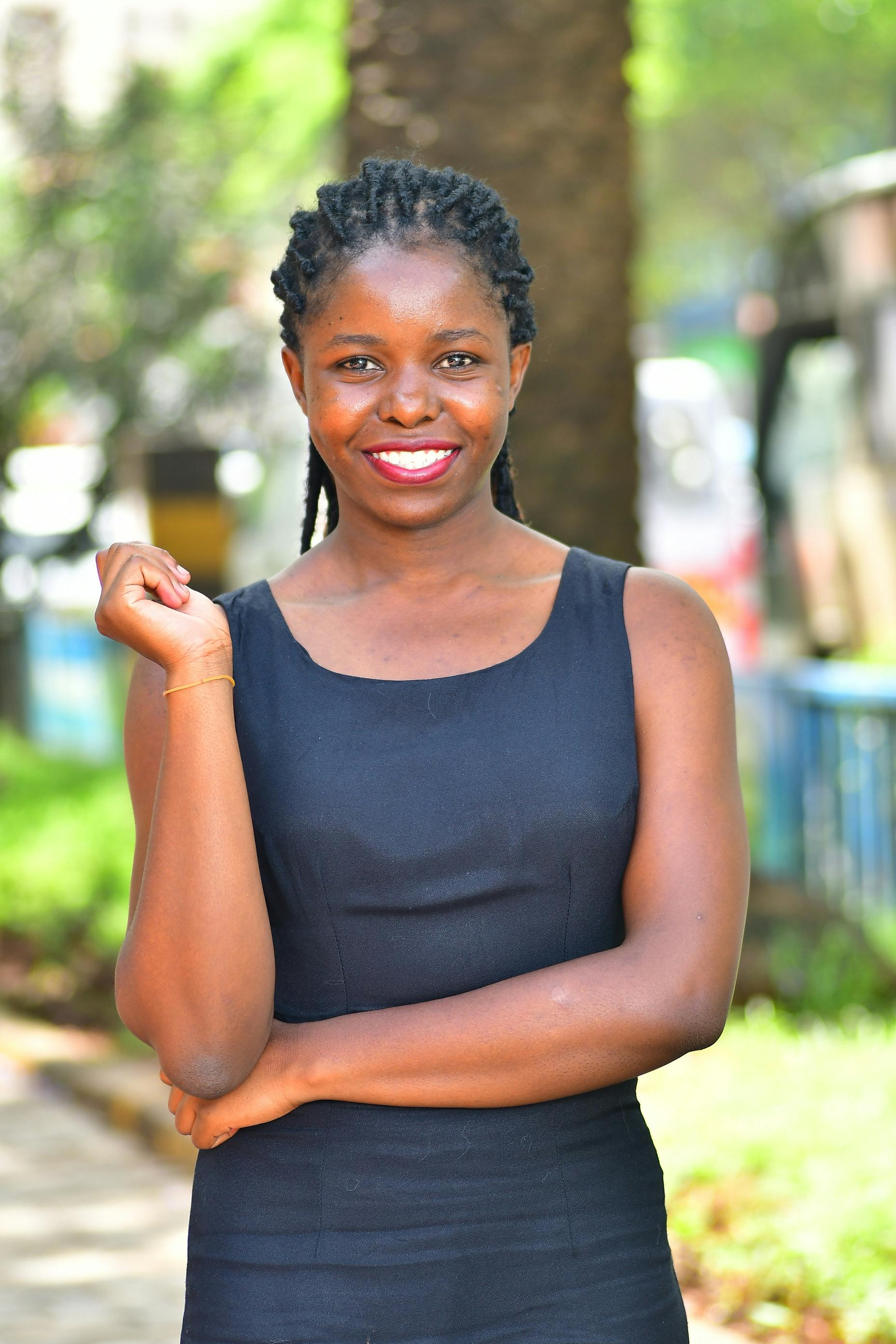 Bright portrait of a smiling African woman outdoors in Nairobi, Kenya on a sunny day.