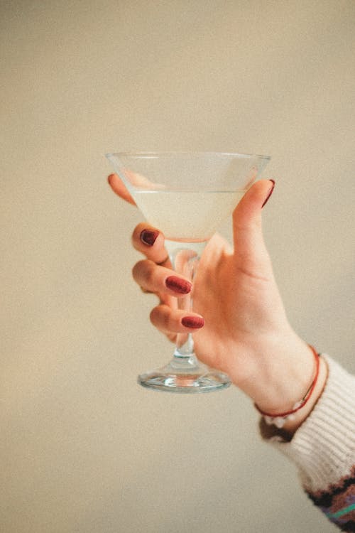 Hand Holding Glass of Alcohol