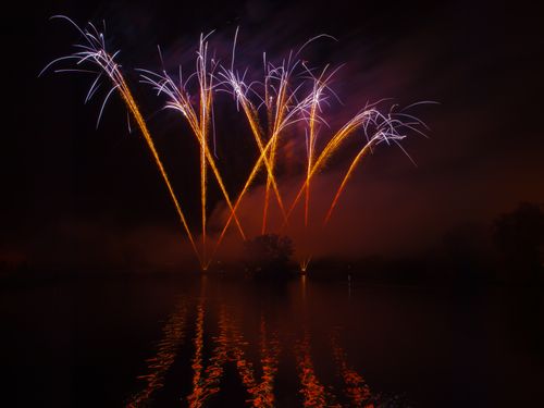 Free A vibrant fireworks display illuminating the night sky and lake in Essex, England. Stock Photo