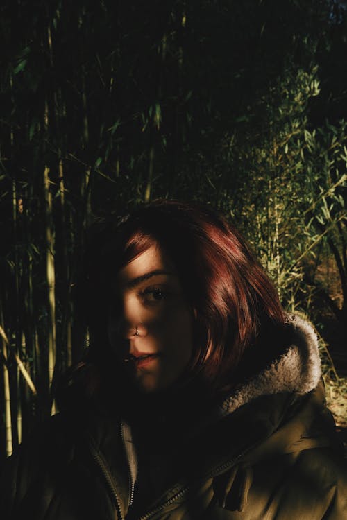 Brunette Woman in Shadow in Forest 