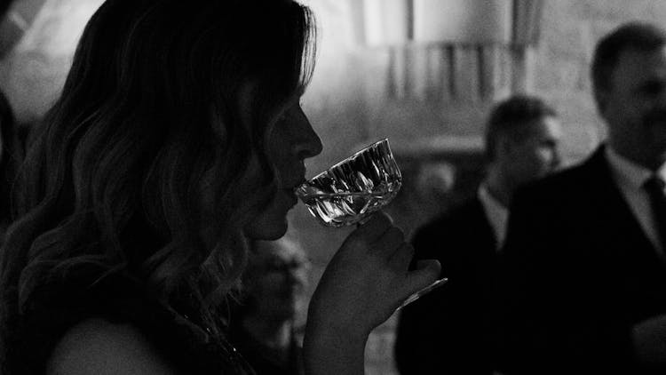 A Woman Drinking At A Party