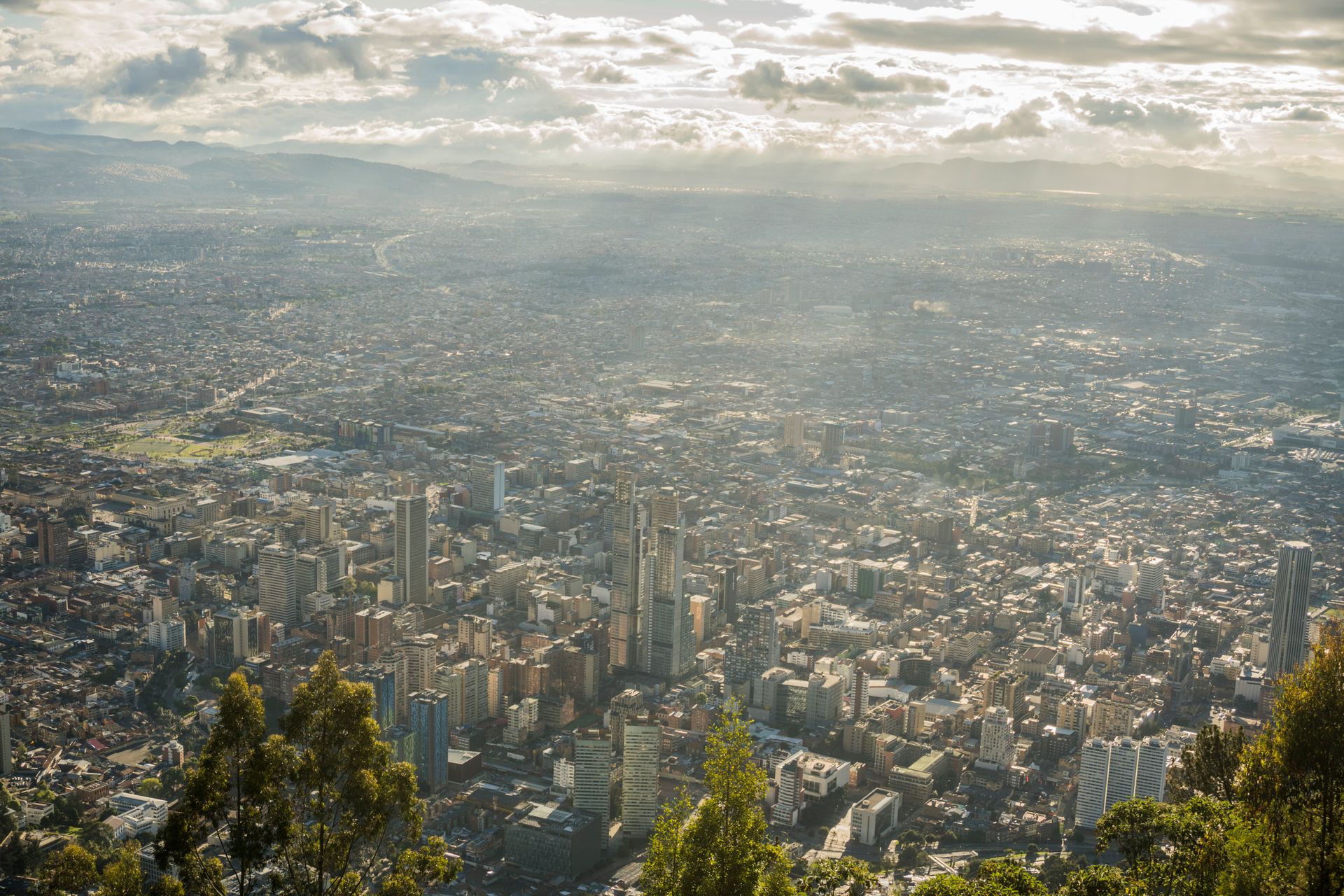 Stunning aerial view of Bogotá's urban landscape under a cloudy sky.