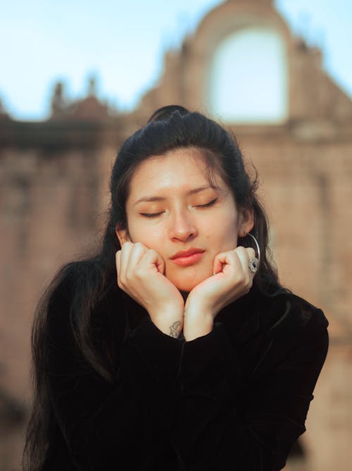 Portrait of a Young Woman Sitting with Eyes Closed