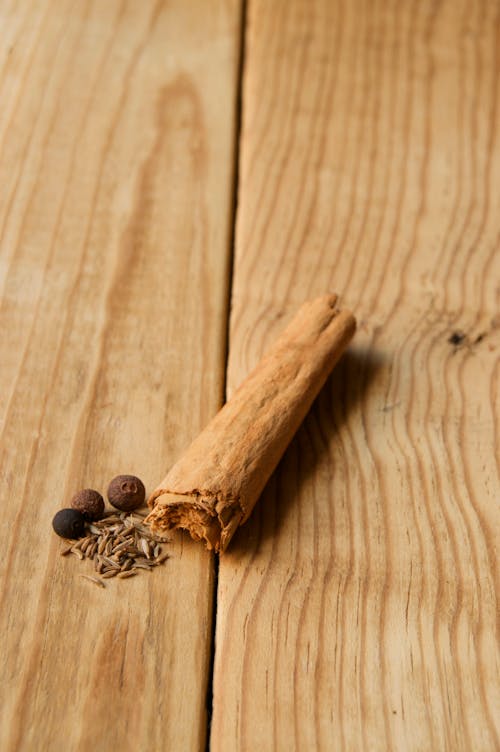 Brown Cinnamon Roll on Brown Wooden Surface