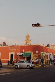 Urban street scene in Puebla, Mexico featuring a Volkswagen Beetle and historic architecture.