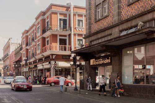 Free Bustling street in Puebla, showcasing local architecture and lively pedestrian activity. Stock Photo