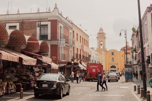 Free Explore a lively street in Puebla, Mexico, full of colorful architecture and bustling activity. Stock Photo