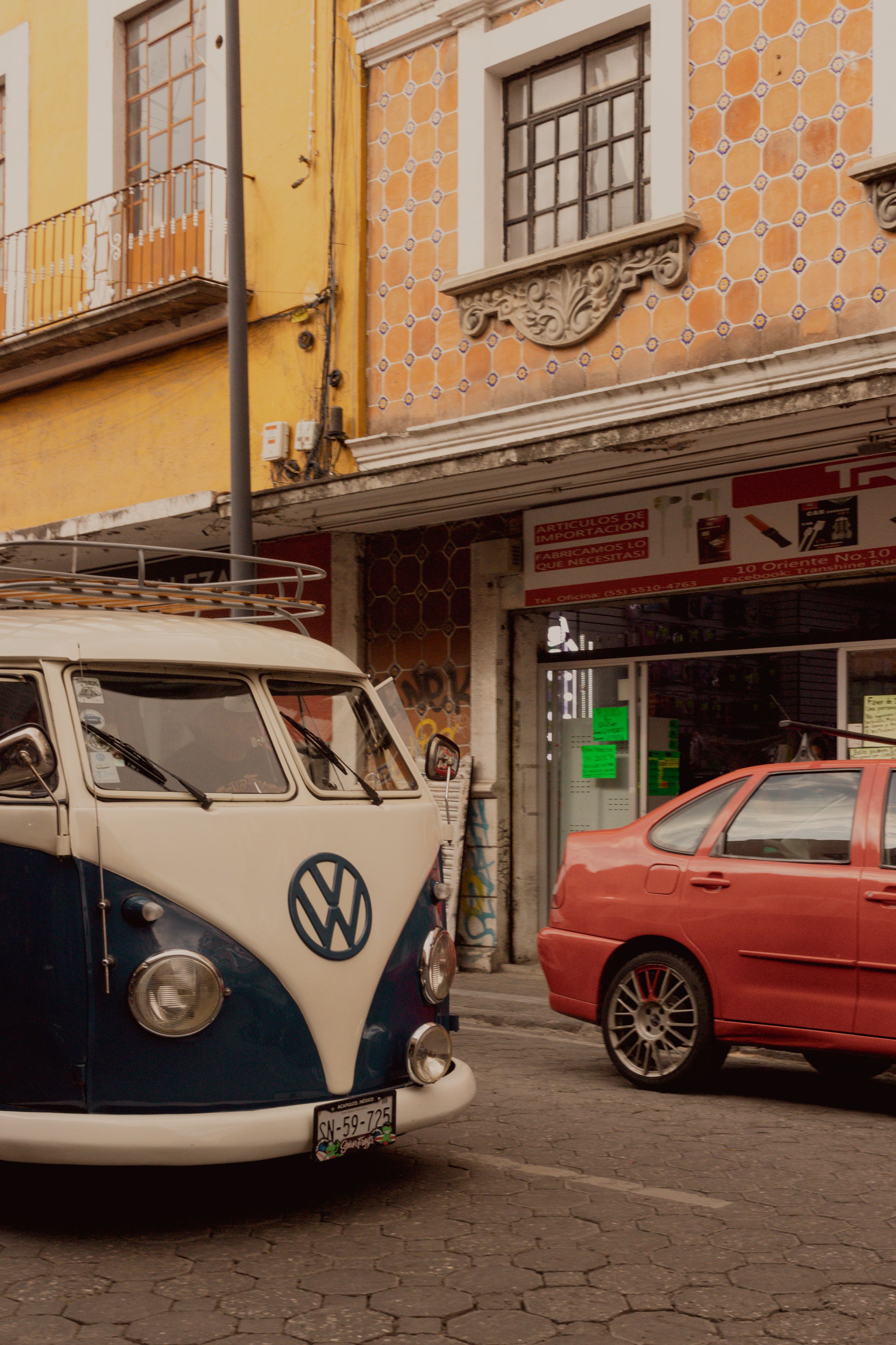 Classic Volkswagen van parked in Heroica Puebla de Zaragoza, showcasing urban street life.