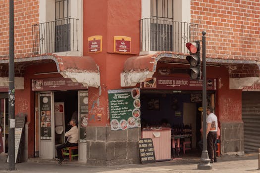Charming urban corner with a traditional restaurant in Puebla, Mexico, capturing local life.