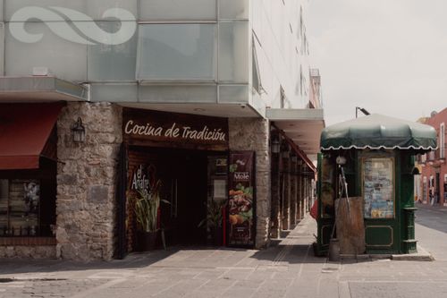 Free Street view in Puebla, Mexico featuring a traditional restaurant and urban architecture. Stock Photo