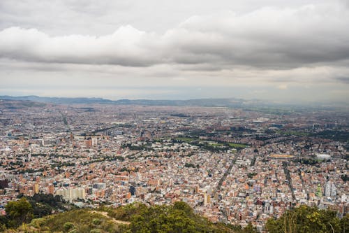 Aerial View of a Large City under a Cloudy Sky 