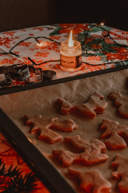 A Tray with Raw Christmas Cookies and a Candle 