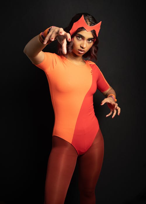Woman Posing in Orange Bodysuit