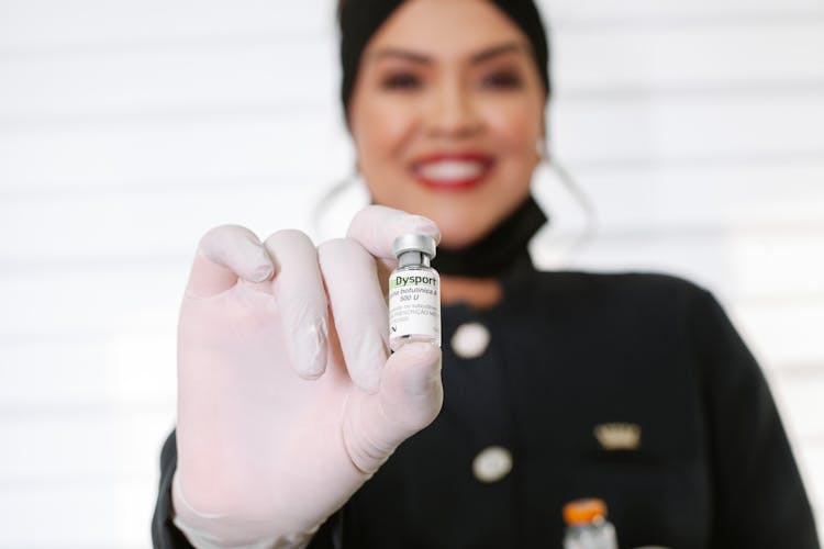 Woman Holding A Bottle Of Medicine 