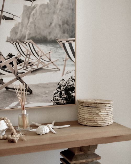 Free Elegant coastal-themed interior with a beach photo and stylish decor elements. Stock Photo
