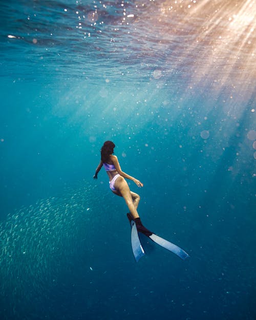 Brunette Woman Diving in Sea