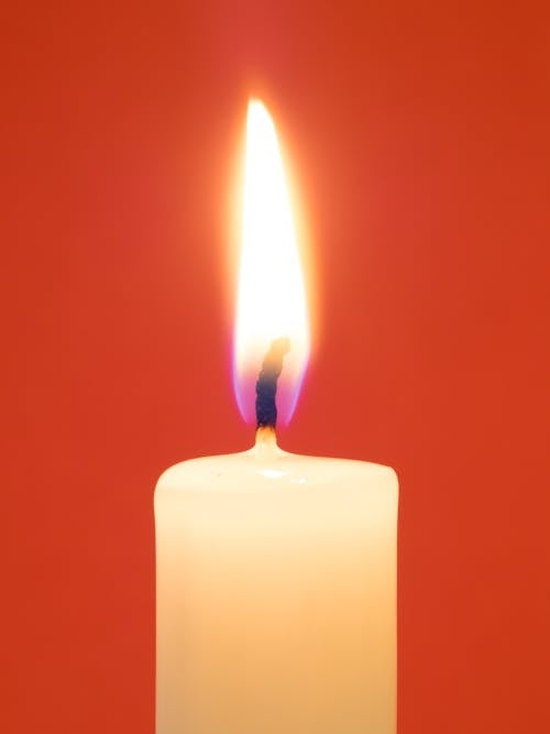 Burning Candle on a Red Background