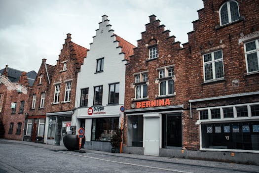 Traditional brick buildings in a Belgian town square showcasing historic architecture.