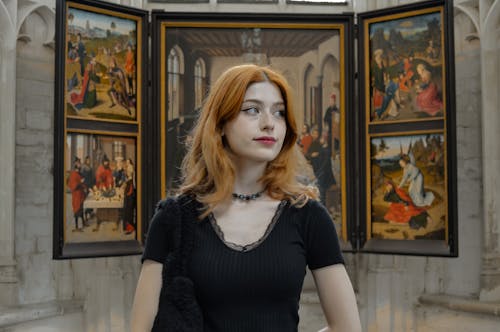 Portrait of Redhead Woman with Painting on Wall behind