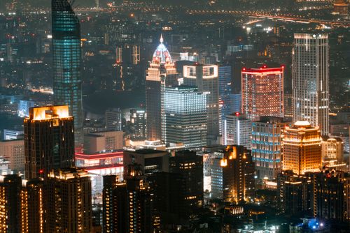 Free A vibrant night view of Taipei's illuminated skyline with towering skyscrapers. Stock Photo