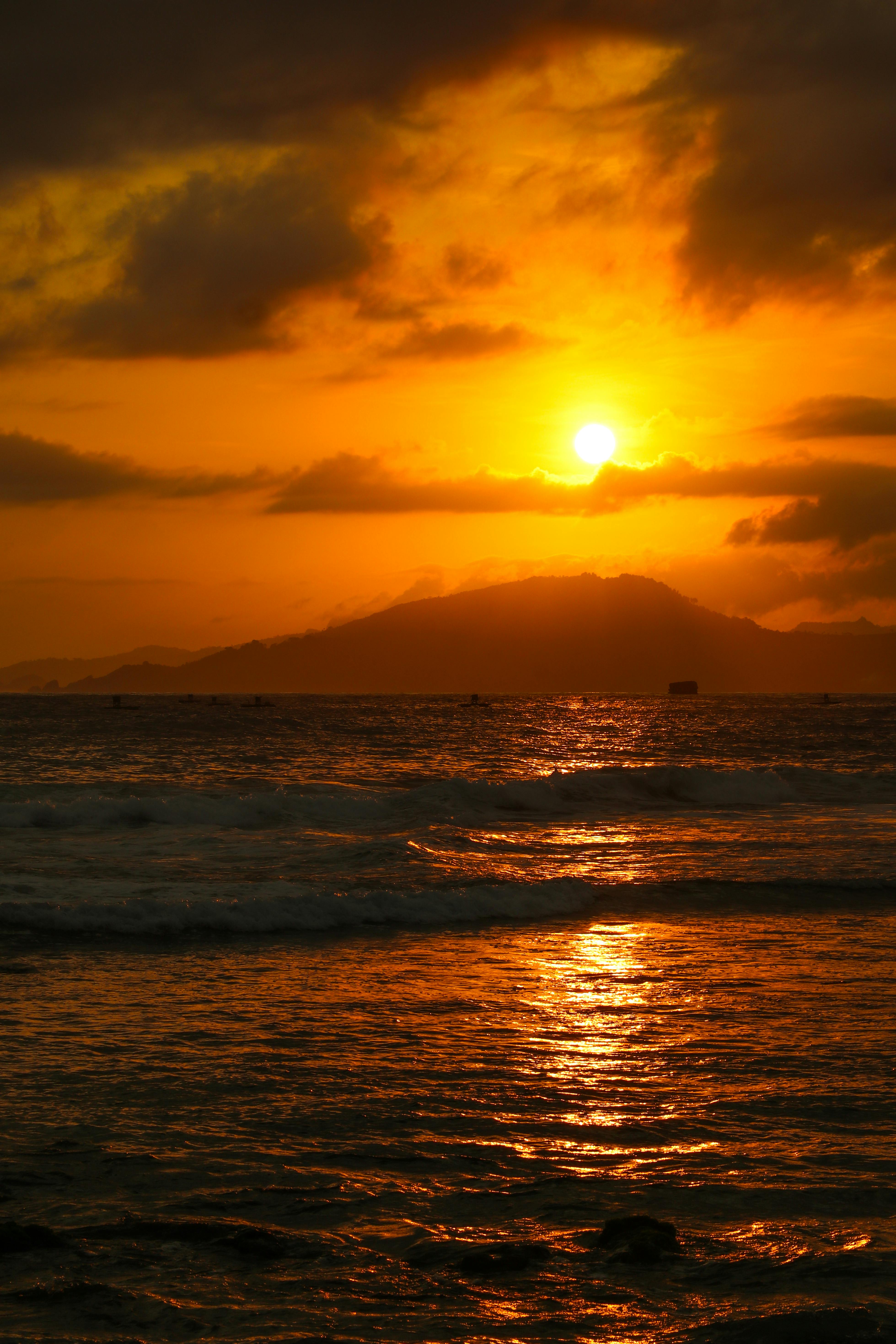 Breathtaking view of a golden sunset casting reflections over calm ocean waves.