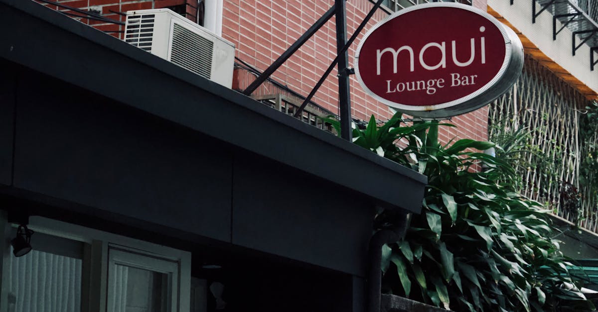 Photo by Song Ning Chan Street view of 'Maui Lounge Bar' exterior with lush ivy, urban setting.
