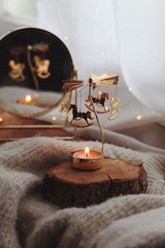 Warm and inviting setup with candle and rocking horse ornament reflecting in mirror for home decor inspiration.