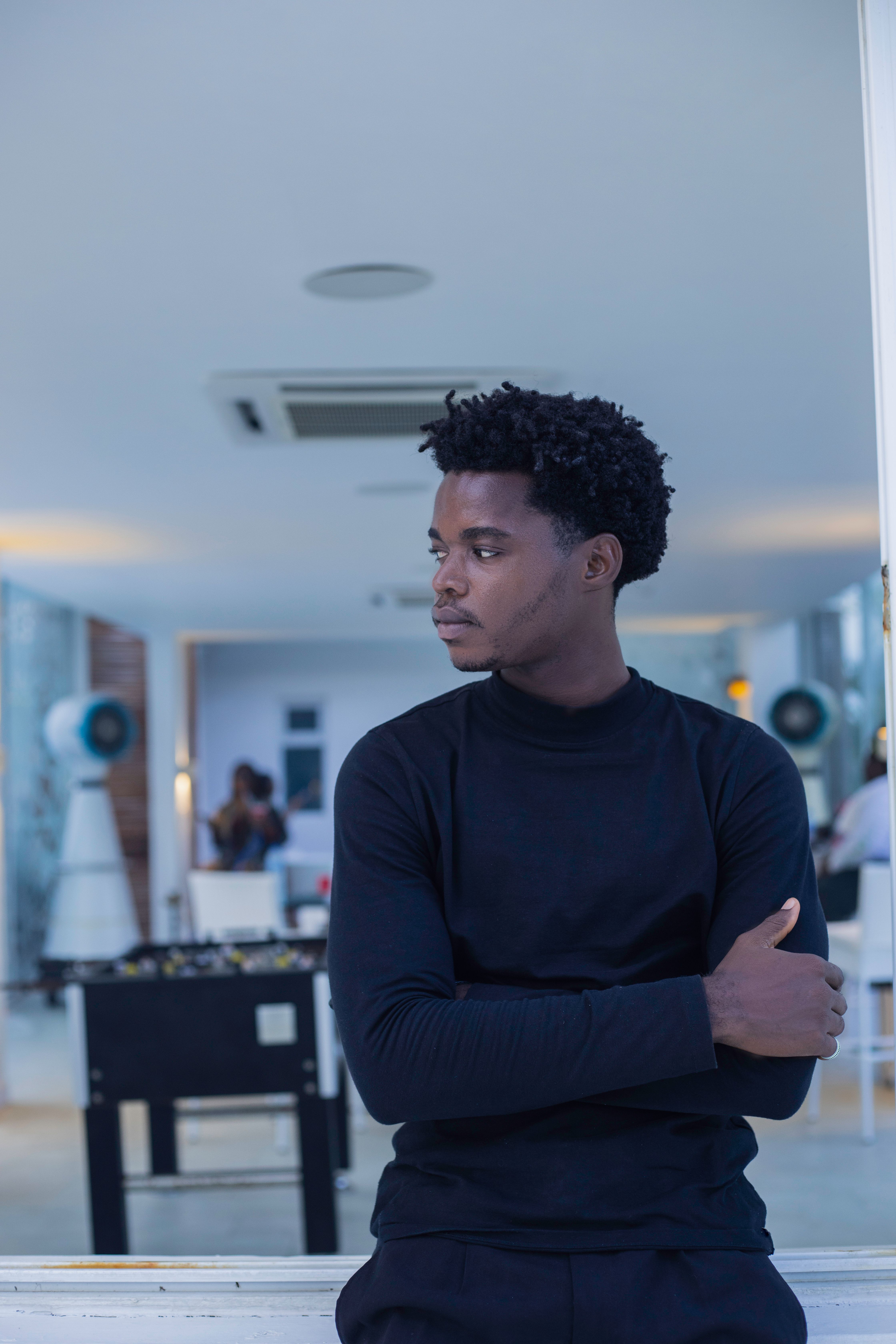 Man Wearing Black Turtleneck on a Terrace · Free Stock Photo