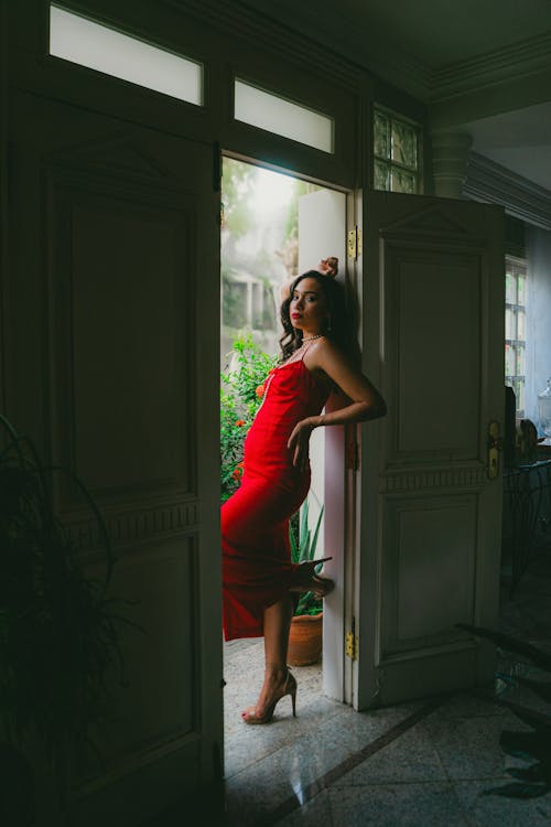 Attractive Woman in Red Dress Posing in Doorway