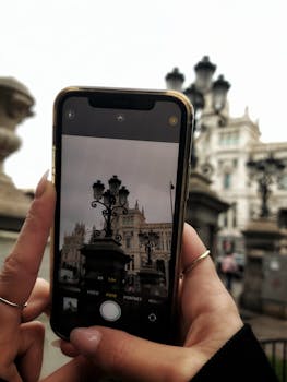 A smartphone photograph of vintage street architecture in an urban setting, emphasizing technology's role in capturing cityscapes.