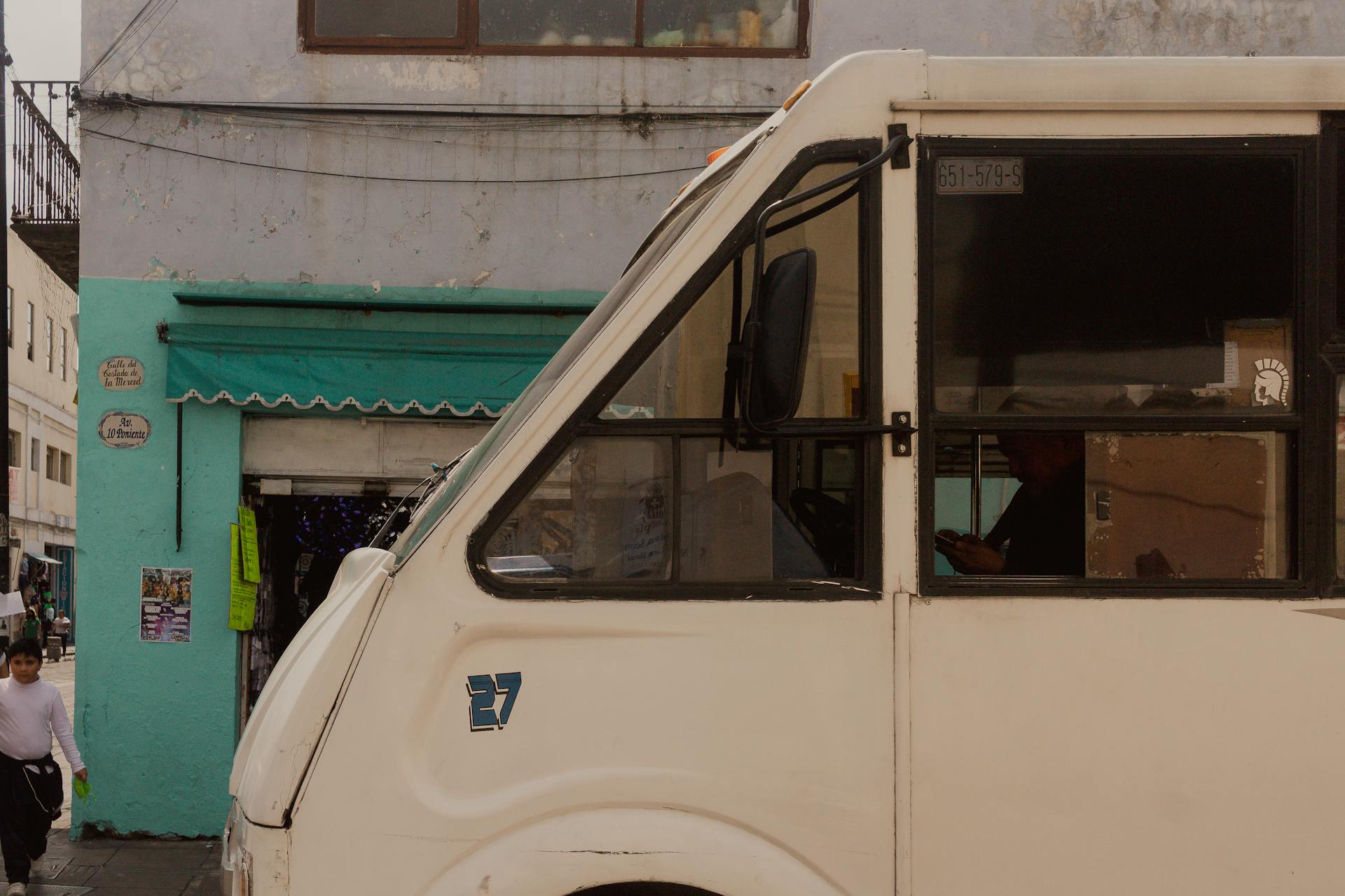 Urban street view featuring a white van in Puebla, Mexico with vibrant surroundings.