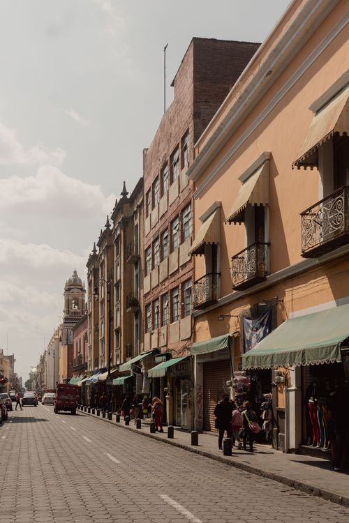Free Historic street in Puebla, Mexico with vibrant colonial architecture on a sunny day. Stock Photo