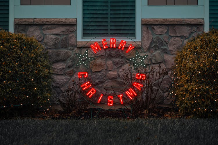 Christmas Sign And Lights In A Garden