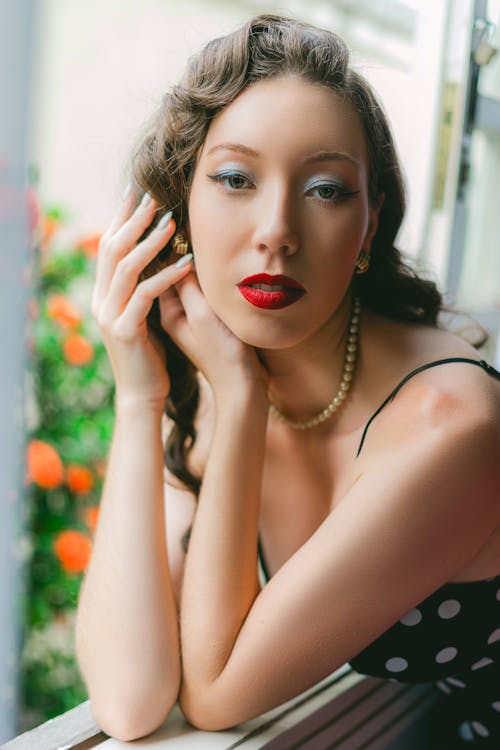 Portrait of a Beautiful Brunette Leaning on a Window Sill