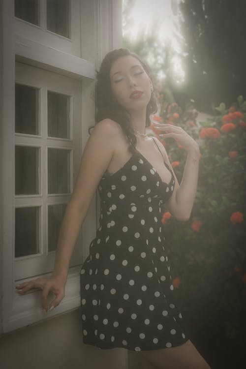 Portrait of a Female Model Wearing a Polka Dot Dress Posing Outdoors